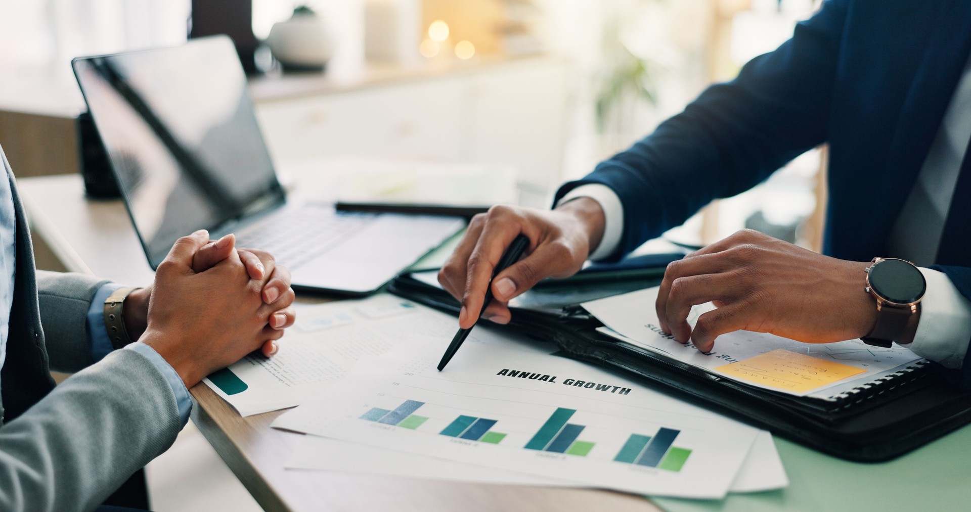 Business people, hands and documents with laptop or statistics for company profit, growth or graph at office. Closeup, employees or analyst pointing with chart for financial revenue or performance